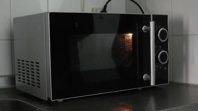 Turning microwave on, on a long runtime and turning it off- wideshot