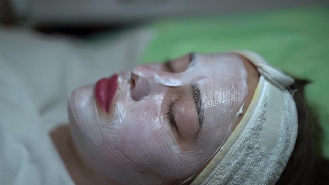 Female model with beauty facepack waiting/relaxing at a salon, close up