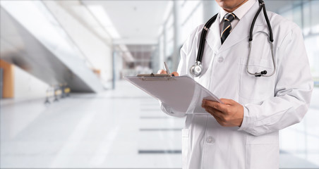 young doctor with hospital background