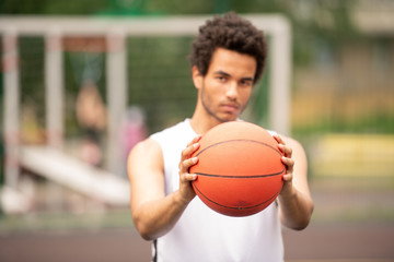Hands of young contemporary active basketball player passing ball