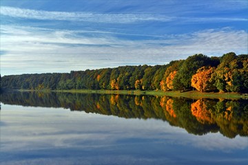 reflection of the yellowed forest in the water of the lake