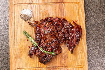 food, delicious and craft concept - cutting horse meat steak on wooden desk