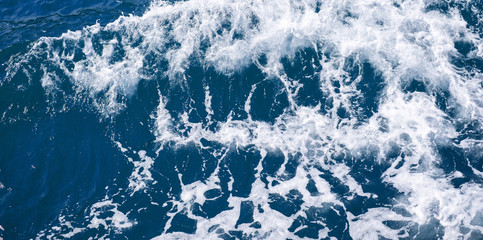 Blue frothy surface of sea water for the designs decoration and nature background concept