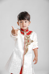 Cute Indian little boy in ethnic wear and giving cute expression