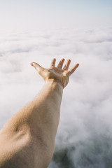 Hand Reaching Clouds In Sky