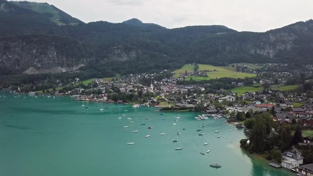 Flight around Sankt Gilgen town and marina on Wolfgangsee, Salzkammergut, Upper Austria.
