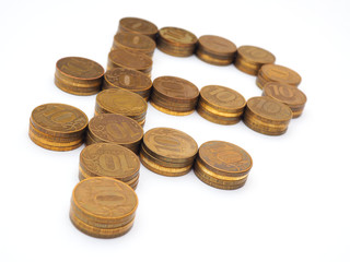 The sign of the Russian ruble, lined with piles of 10-ruble coins