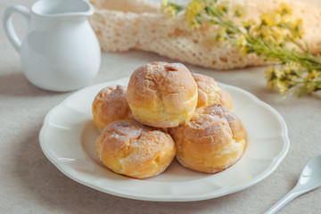 Cream puffs on white plate