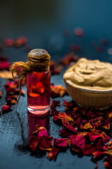 Ubtan/face mask/face pack of Multani mitti or fuller's earth on wooden surface in a glass bowl consisting of Multani mitti and rose water for the remedy or treatment of oily skin.On wooden surface.