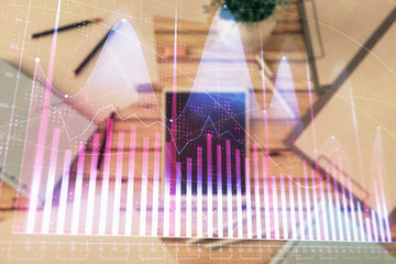 Double exposure of forex graph on digital tablet laying on table background. Concept of market analysis