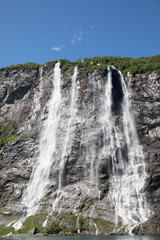 Mountain landscape with blue sky. Beautiful nature Norway. Geiranger fjord. Seven Sisters Waterfall