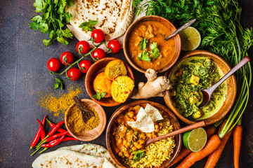 Food traditional Indian cuisine. Dal, palak paneer, curry, rice, chapati, chutney in wooden bowls...