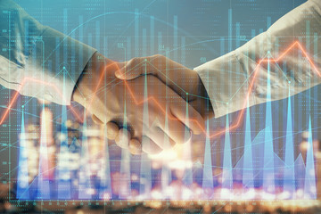 Double exposure of financial chart on cityscape background with two businessmen handshake. Concept of financial analysis and investment opportunities