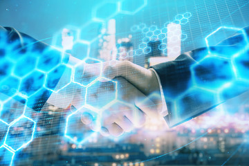Double exposure of abstract technology drawing on cityscape background with two businessmen handshake. Concept of tech role in business