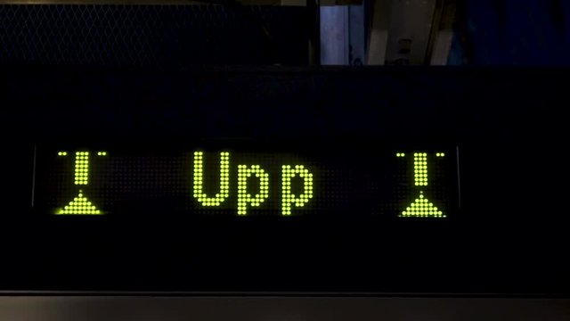 Electronic board with arrows in the subway. Animations of yellow arrows going up on a LED panel