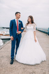 Wedding couple on the yacht, lovers posing on the yacht