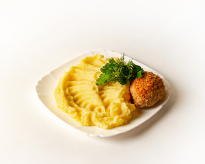Chicken cutlet with mashed potatoes and greens