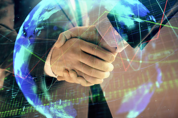 Multi exposure of forex graph and world map on abstract background with two businessmen handshake. Concept of success on international markets