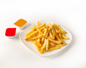 French fries on a plate with two kinds of sauce on the left