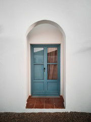 old blue wooden door with glass windows