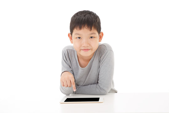 Asian boy using tablet computer isolated on white background. Look at Camera Pose.