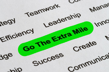 Fototapeta premium Go The Extra Mile - Business Buzzwords, printed on white paper and highlighted