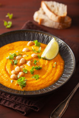creamy carrot chickpea soup on dark rustic background