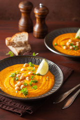 creamy carrot chickpea soup on dark rustic background