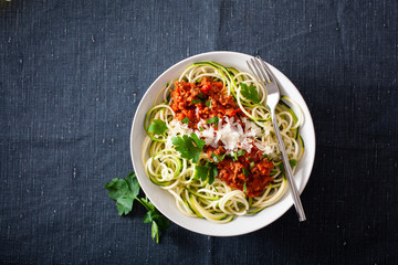 keto paleo zoodles bolognese: zucchini noodles with meat sauce and parmesan