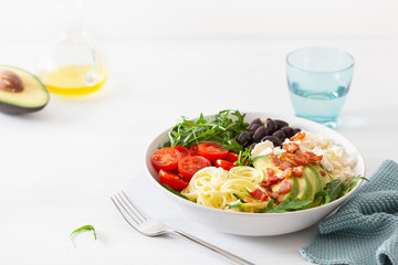 ketogenic lunch bowl: spiralized courgette with avocado, tomato, feta cheese, olives, bacon
