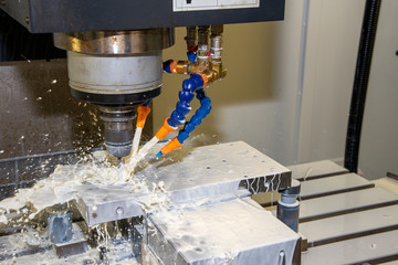 The CNC milling machine drilling the mould parts with drill tool. The Hole drilling process with...