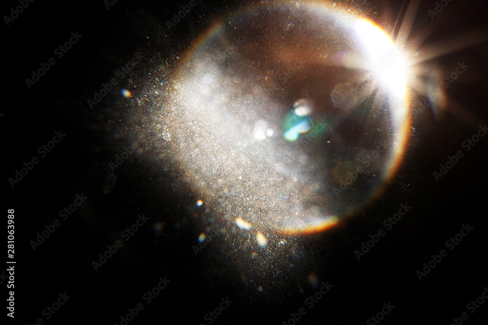 Poster Lens Flare. Light over black background. Easy to add overlay or screen filter over photos. Abstract sun burst with digital lens flare background. Gleams rounded and hexagonal shapes, rainbow halo.