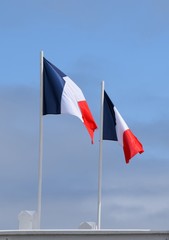 two French national flags side by side in the wind
