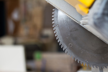 Close-up stationary circular saw on a carpentry table on a blurred background of a carpentry...