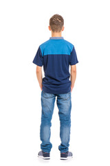 Fototapeta premium Full length portrait of young caucasian teen boy - rear view, isolated on white background. Funny teenager - back view. Handsome child with hands in pockets.