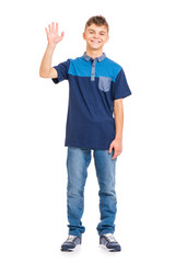 Full length portrait of young caucasian teen boy isolated on white background. Funny teenager stretching his right hand up for greeting. Handsome child waving hand, looking at camera and smiling. - 281065195