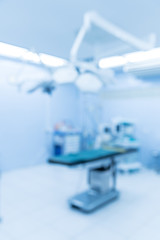 Blurry empty interior operating room and modern equipment in hospital.Medical device for surgeon surgical emergency patient in blue tone style.Save life medical treatment concept.