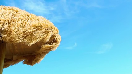 View from below of beautiful thatched umbrellas on the beach, great recreation and relaxation.