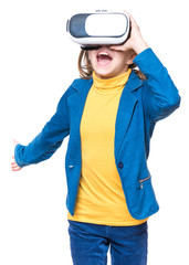Amazed little girl wearing virtual reality goggles watching movies or playing video games, on white. Surprised kid looking in VR glasses. Emotional portrait of child experiencing 3D gadget technology.