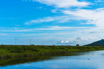 Path on the dam with blue sky and white cloud