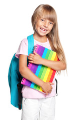 Happy little girl with backpack and books isolated on white background. Cute child back to school.