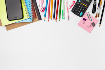 Top view of school supplies on a white background