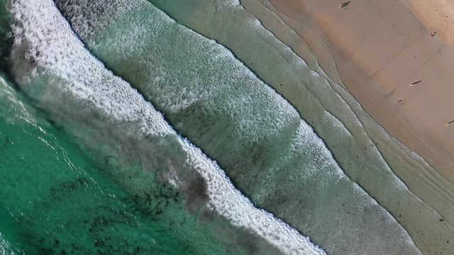 ocean waves sandy beach with people bathing in the water view from drone Lanzada beach Galicia Spain 4k video