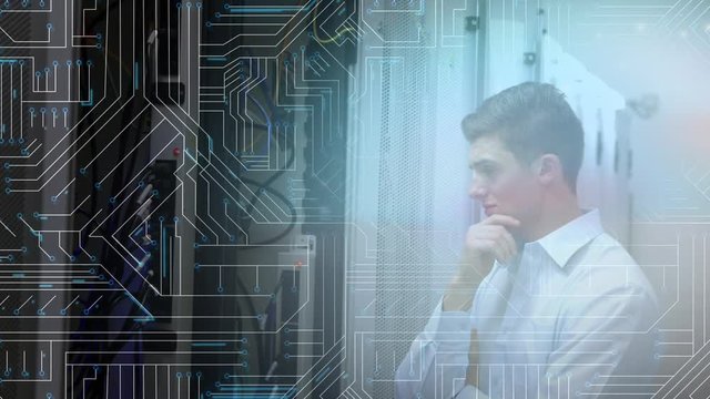 Man looking at mainframe computer in a server room