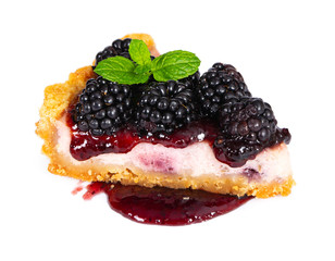 Piece of cheesecake with fresh blackberries and mint