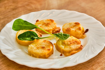 Baked yellow zucchini with mozzarella and parmesan cheese