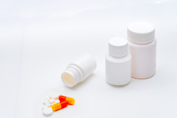 Tablets, vials and capsules on a white background