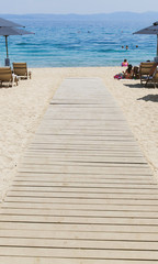 Wooden path on sand beach summer seascape