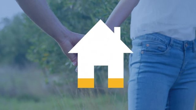 Coupel holding hands and house filling yellow