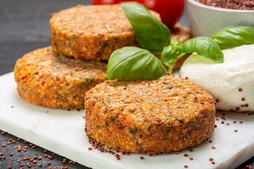 Tasty vegetarian burgers made from healthy quinoa, basil, tomatoes and mozzarella cheese